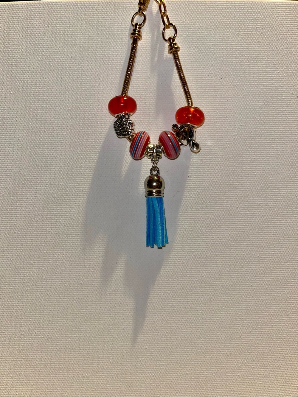 Gold-Tone Snake Chain Charm Bracelet w/Red & Blue Accents, Music Note & Crown